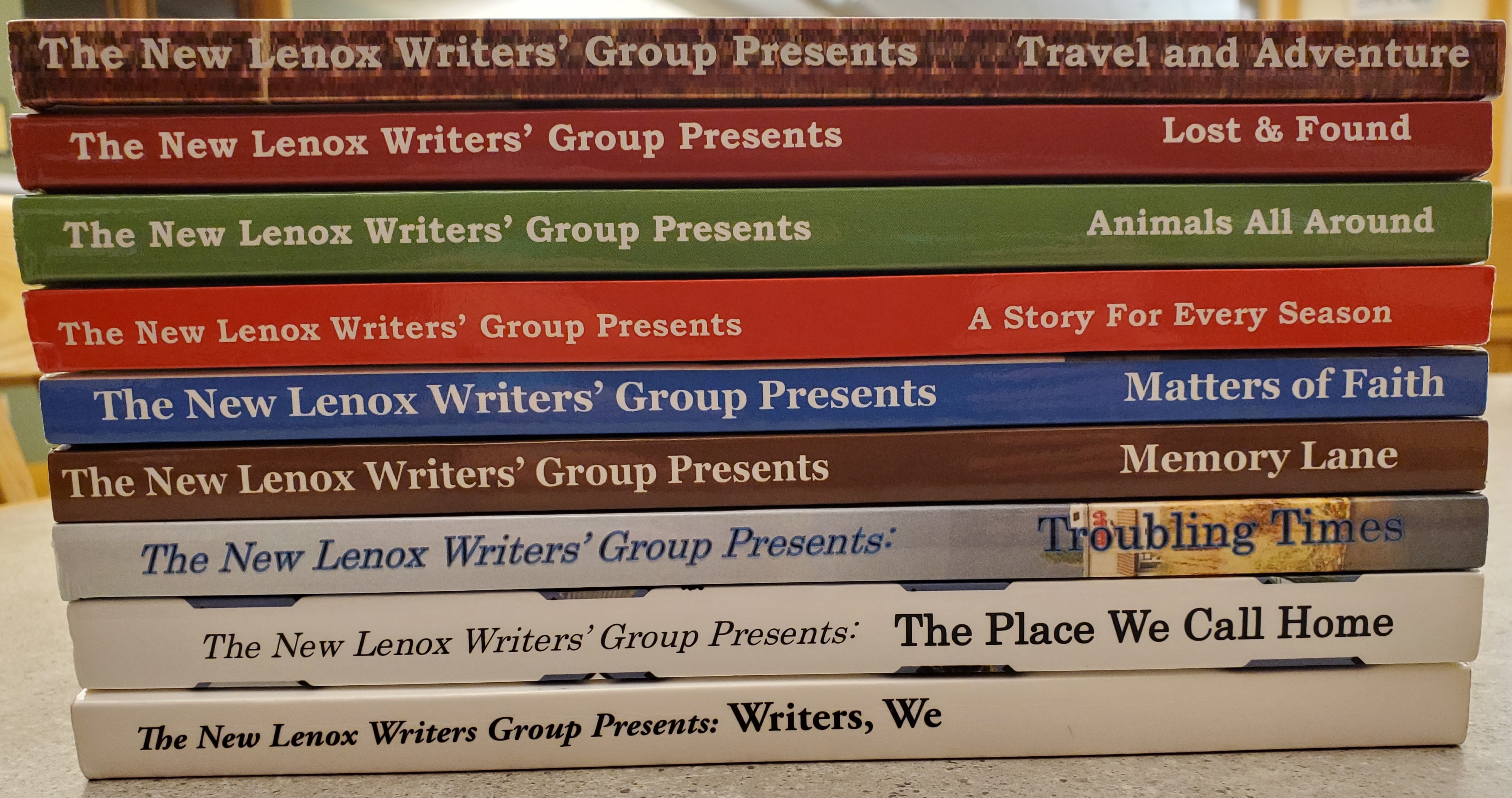 Stack of anthologies written by New Lenox Writers Group