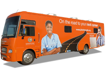Orange mobile home with a graphic of a road on it as well as the Will County Mobile Workforce Center logo.