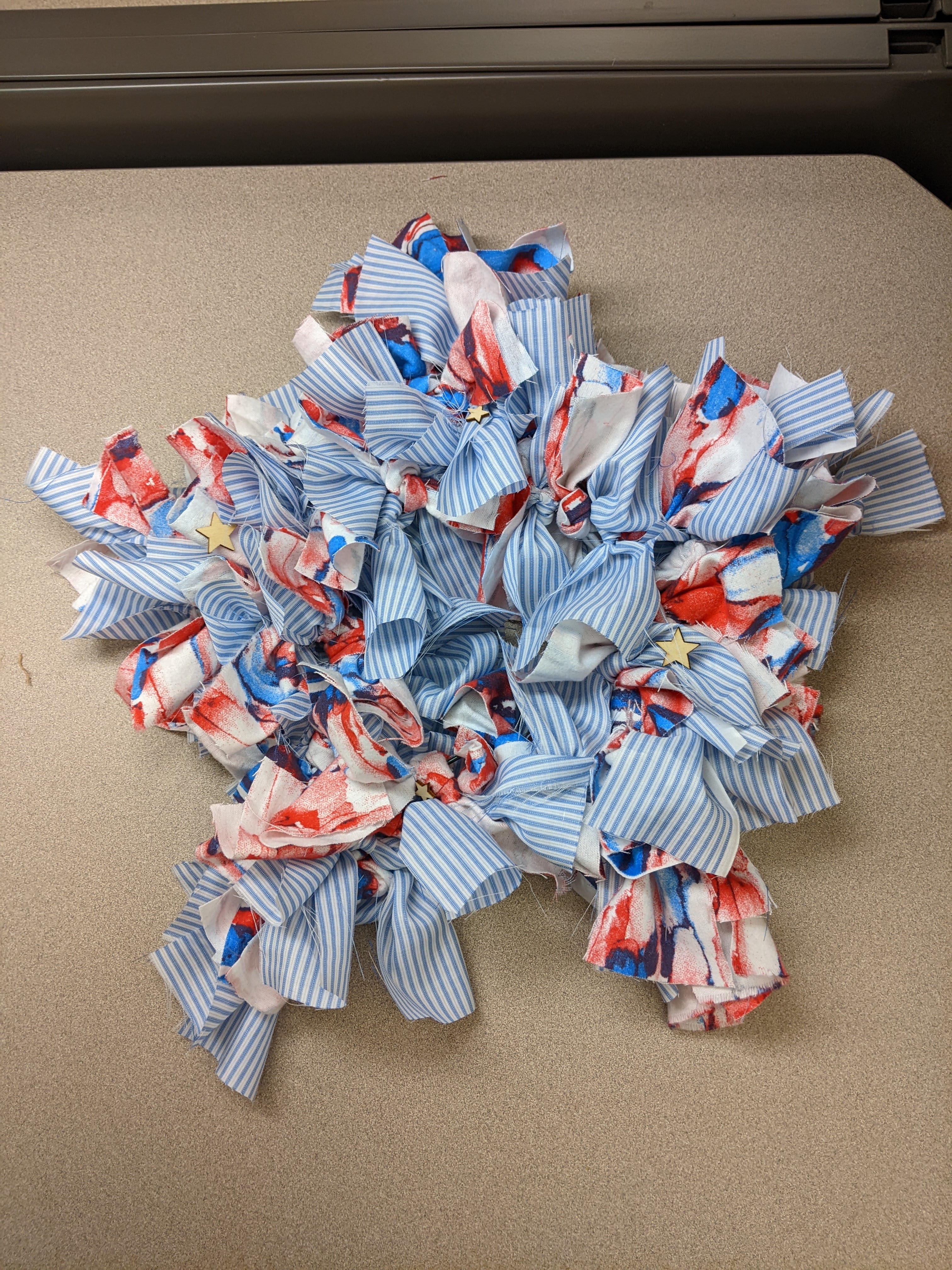 Star shaped wreath with red, white and blue fabric. 
