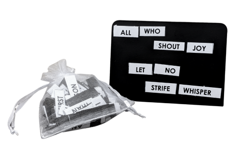 White strips of magnet with black text. Some of the strips are in a translucent white bag. Others are arranged against a black board to read "All who shout joy/ let no strife whisper."