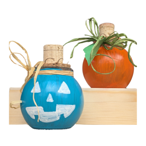 Displays two round jars as examples of the craft project. One is painted orange and tied with a leaf to resemble a traditional pumpkin, the other is painted teal with a white jack-o-lantern face on it.